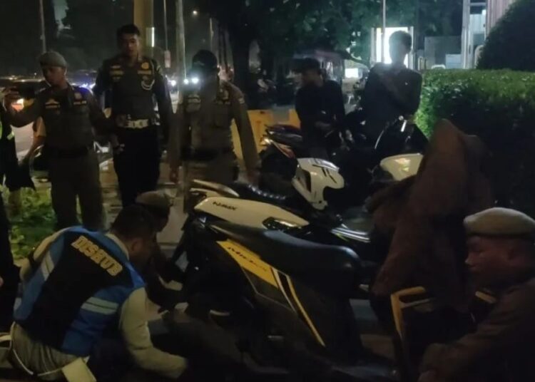 Petugas menertibkan kendaraan yang parkir sembarangan di Jalan Khatib Sulaiman Padang.