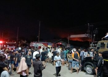 Lokasi kebakaran pabrik karet PT Teluk Luas di Padang masih dipadati warga, kebakaran masih terjadi. (foto: Sumbarkita.id)